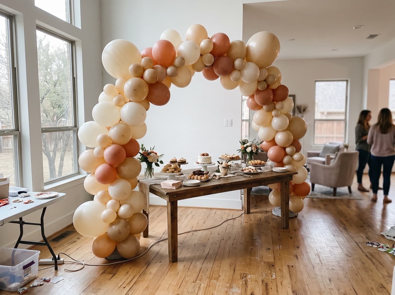 Organic balloon arch in ivory, champagne and terracotta over a dessert table at a Dallas birthday party